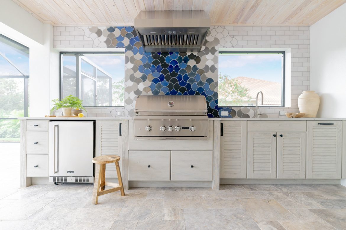 Outdoor kitchen with grill, undercounter fridge, sink and statement tile
